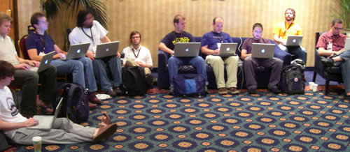 Geeks sitting with their Mac laptops at RailsConf 2006