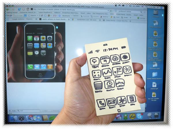 Photo: Hand-drawn iPhone held in front of a monitor showing a real iPhone.
