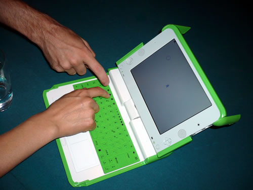 The OLPC and adult hands.