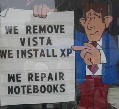 Sign in a Seattle computer store window: “We remove Vista / We install XP”