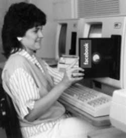 Woman at vintage computer with 8-inch floppy labelled 'Facebook'