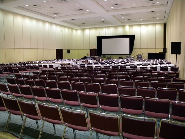 View of a large presentation room, as seen from the back.