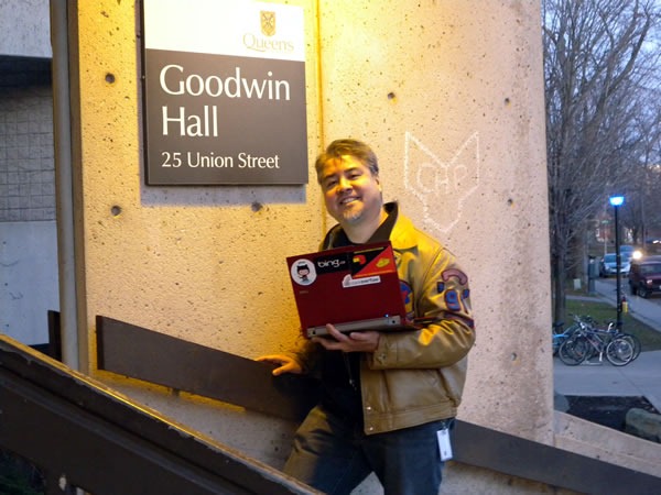 Me and my laptop, posing beside the sign at the entrance of Goodwin Hall