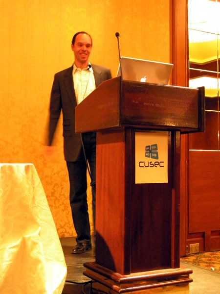 Reg Braithwaite, standing at the lectern, giving his keynote at CUSEC 2010