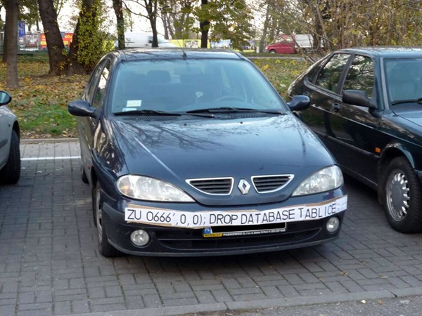 Renault with a banner across its bumper reading "ZU 0666', 0, 0); DROP DATABASE TABLE LICENCE;"