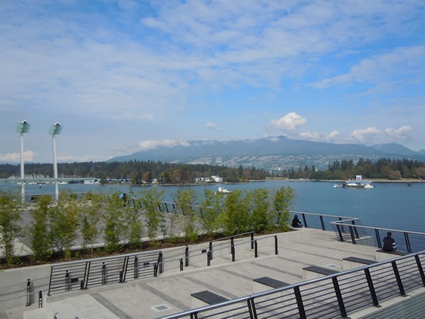 View of a promenade facing the water and mountains