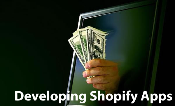 Developing Shopify Apps: Hand holding money emerging from a computer monitor