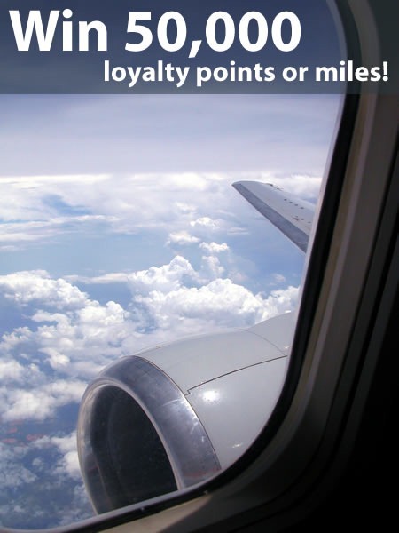 "Win 50,000 loyalty points or miles!": Airplane wing as seen from window