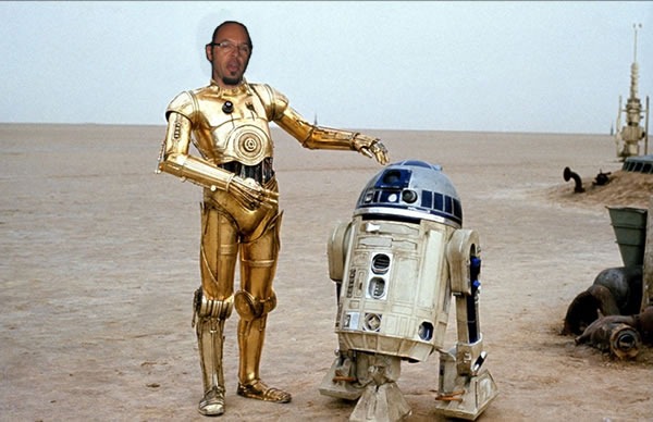 Reg Braithwaite's head on C-3PO's body, standing beside R2-D2 on the Tattooine desert.