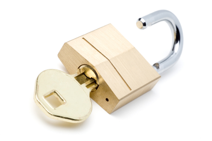 Gold Key Opening a Gold Lock (with Clipping Path)