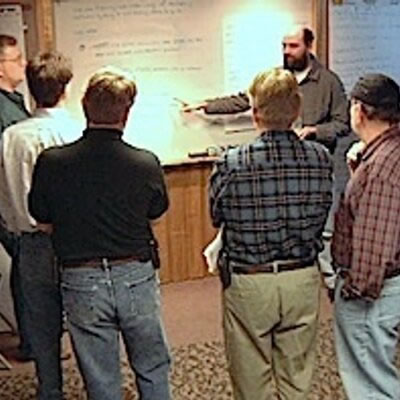 Photo: Some of the signers of the agile manifesto gathered around a whiteboard at their Snowbird get-together.