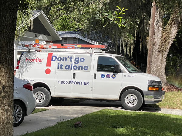 Photo: A van for Frontier, parked in a residential driveway.