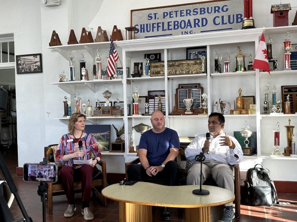 Anitra Pavka moderates as Mark Moskowitz and Kishen Sridharan speak at the St. Petersburg Shuffleboard club.